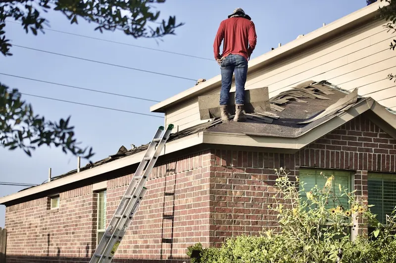Professional roofer working on a residential roof in Post Oak